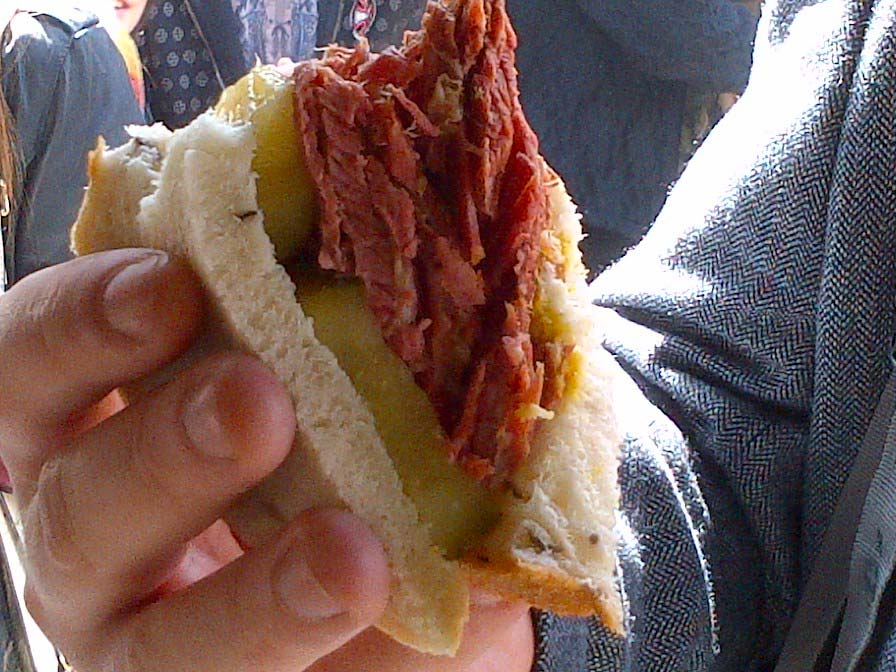 One of the Nana Fanny famous salt beef sandwiches being enjoyed by a customer in Borough MarketImage with link to high resolution version